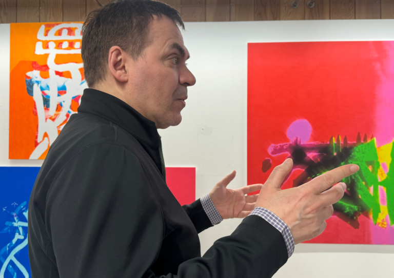 Peter Constantine in front of pieces from the Lost Wor(l)ds exhibtion